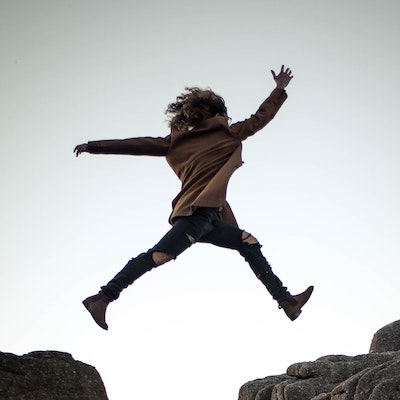 person jumping over a chasm